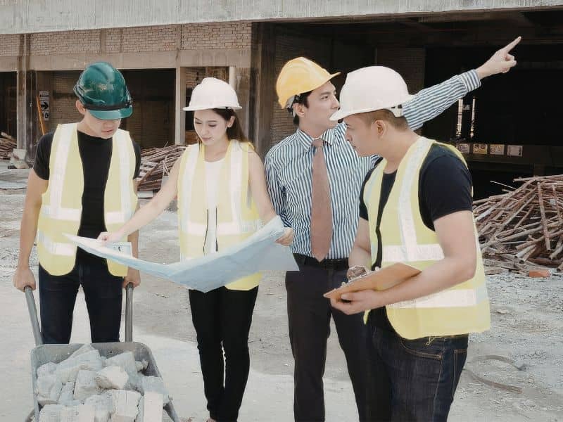 Construction survey team coordinating redevelopment work at an older Pittsburgh commercial property